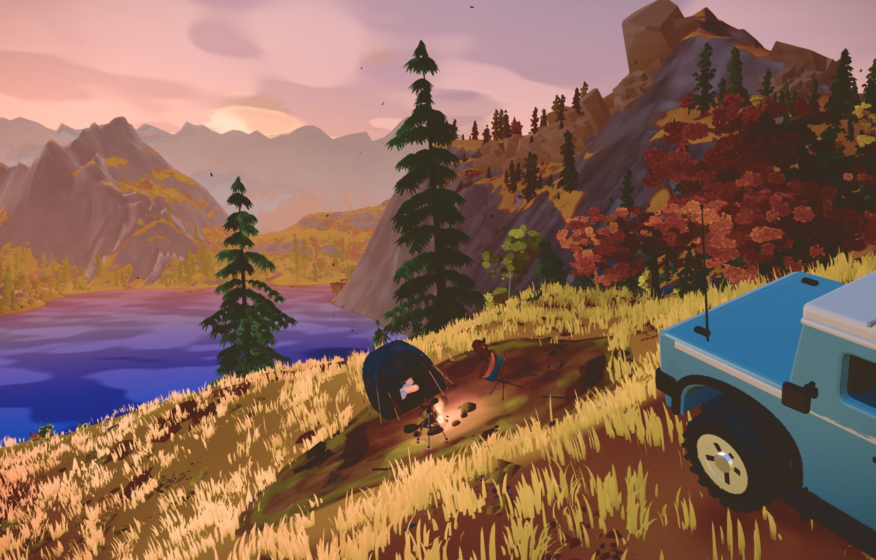 A camp pitched on a grassy slope above a lake at golden hour