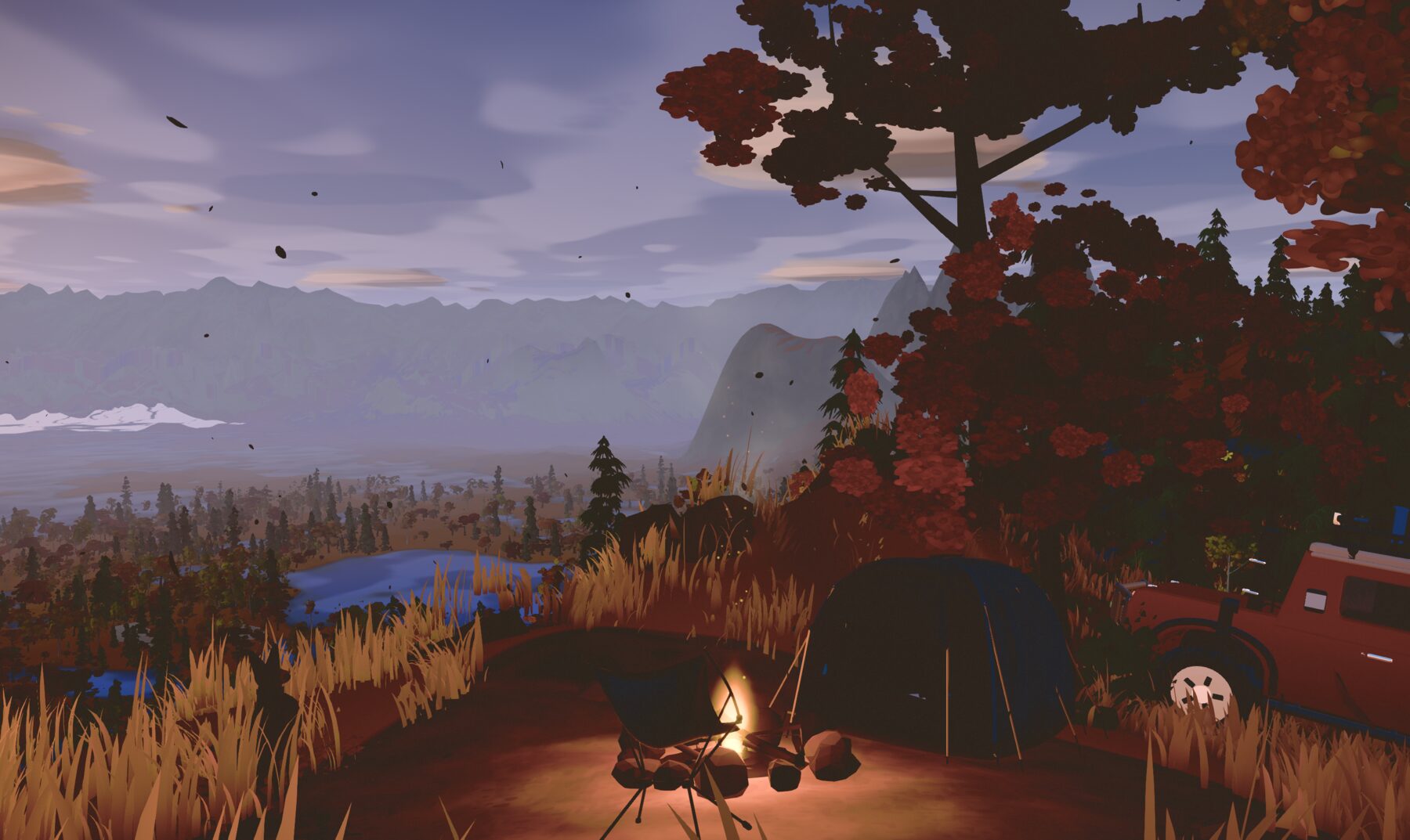 A camp under a red maple at dusk with a lake and mountains beyond