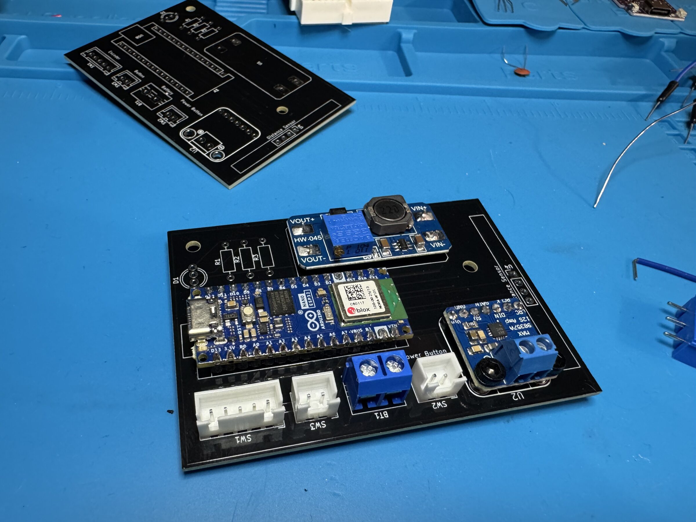 The assembled board: an Arduino Nano ESP32, a boost converter and an I2S amp on a black PCB with white JST connectors