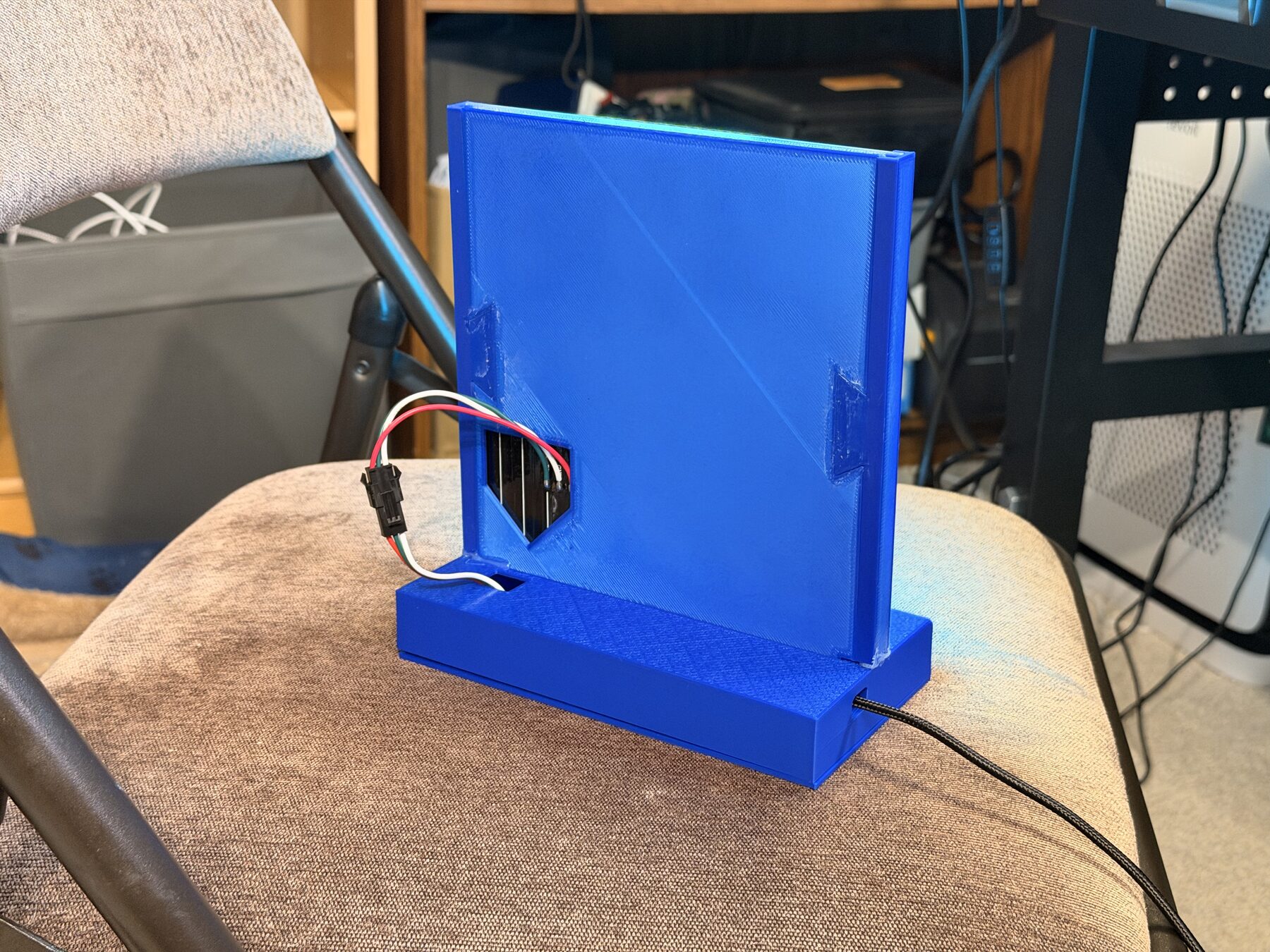 The back of the toy, with the LED wiring coming out of a cutout in the back panel