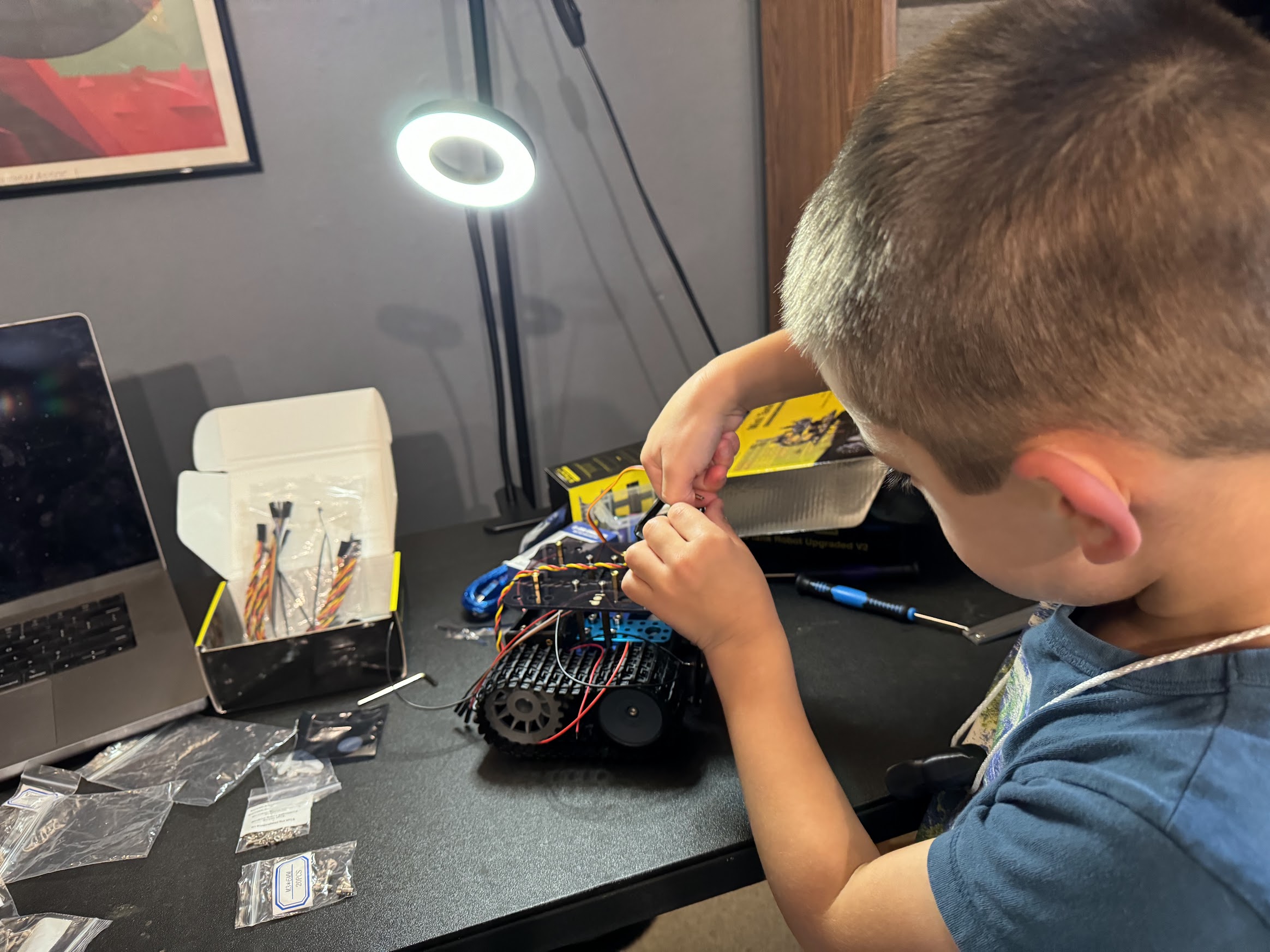 Jacob carefully working on screwing components together