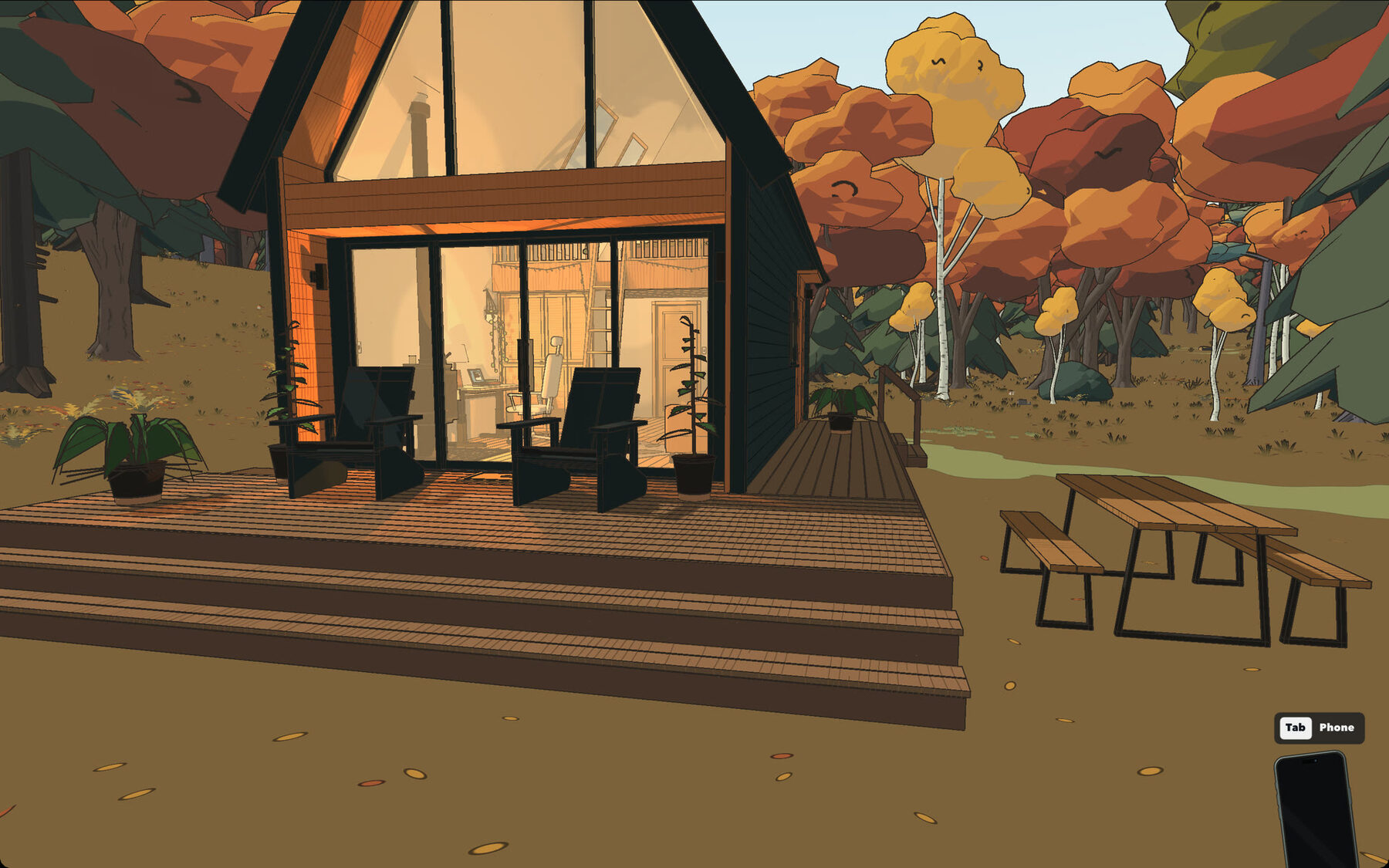 The tiny house at dusk with its windows lit, chairs on the deck and a picnic table