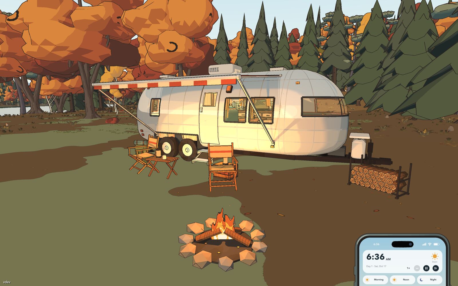 A silver Airstream trailer with a striped awning, camp chairs, a firewood rack and a fire pit